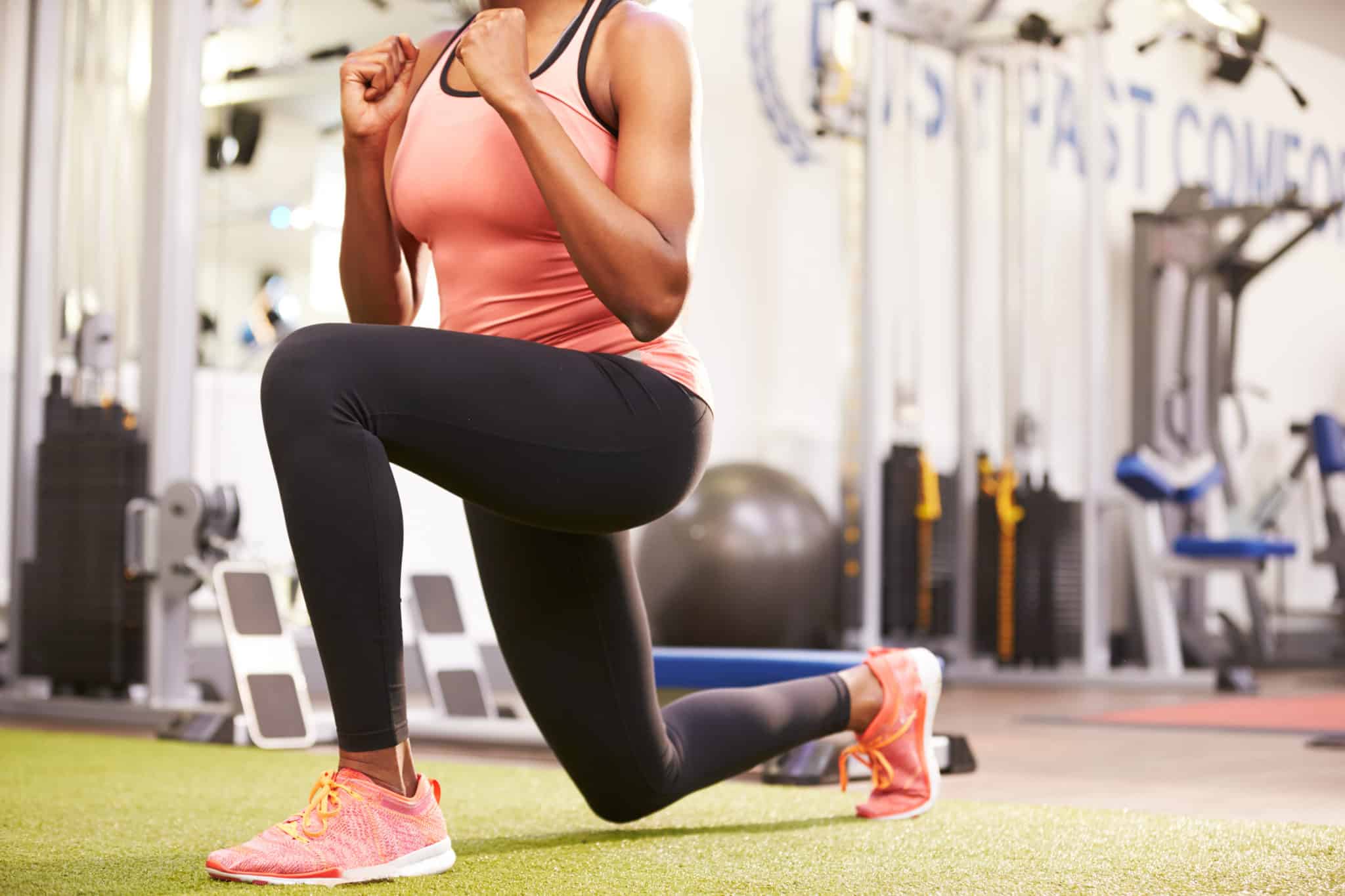 Woman performing basic stationary lunge as a part of a 20 minute full body strength workout