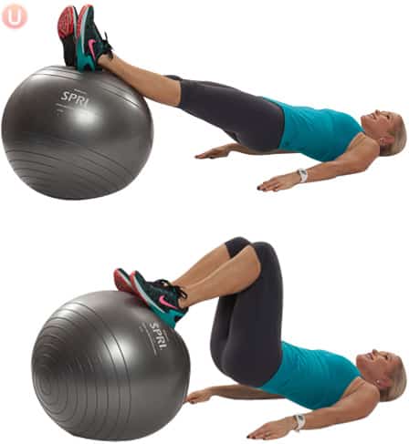 Chris Freytag demonstrating a hamstring curl on a stability ball wearing black yoga pants and blue top.