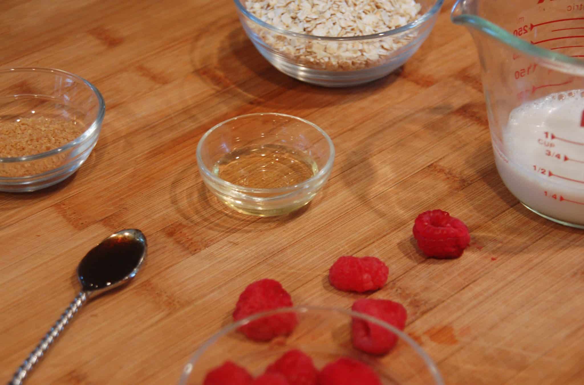 Vanilla Strawberry Overnight Oats Ingredients laid out on wooden cutting board in correct proportions