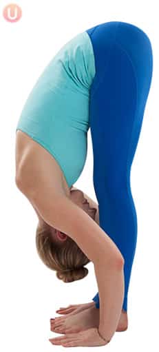 Chloe Freytag demonstrating forward fold in a blue tank top and yoga pants