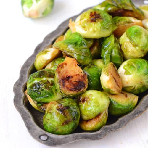 Roasted Brussels sprouts on metal tray on white table