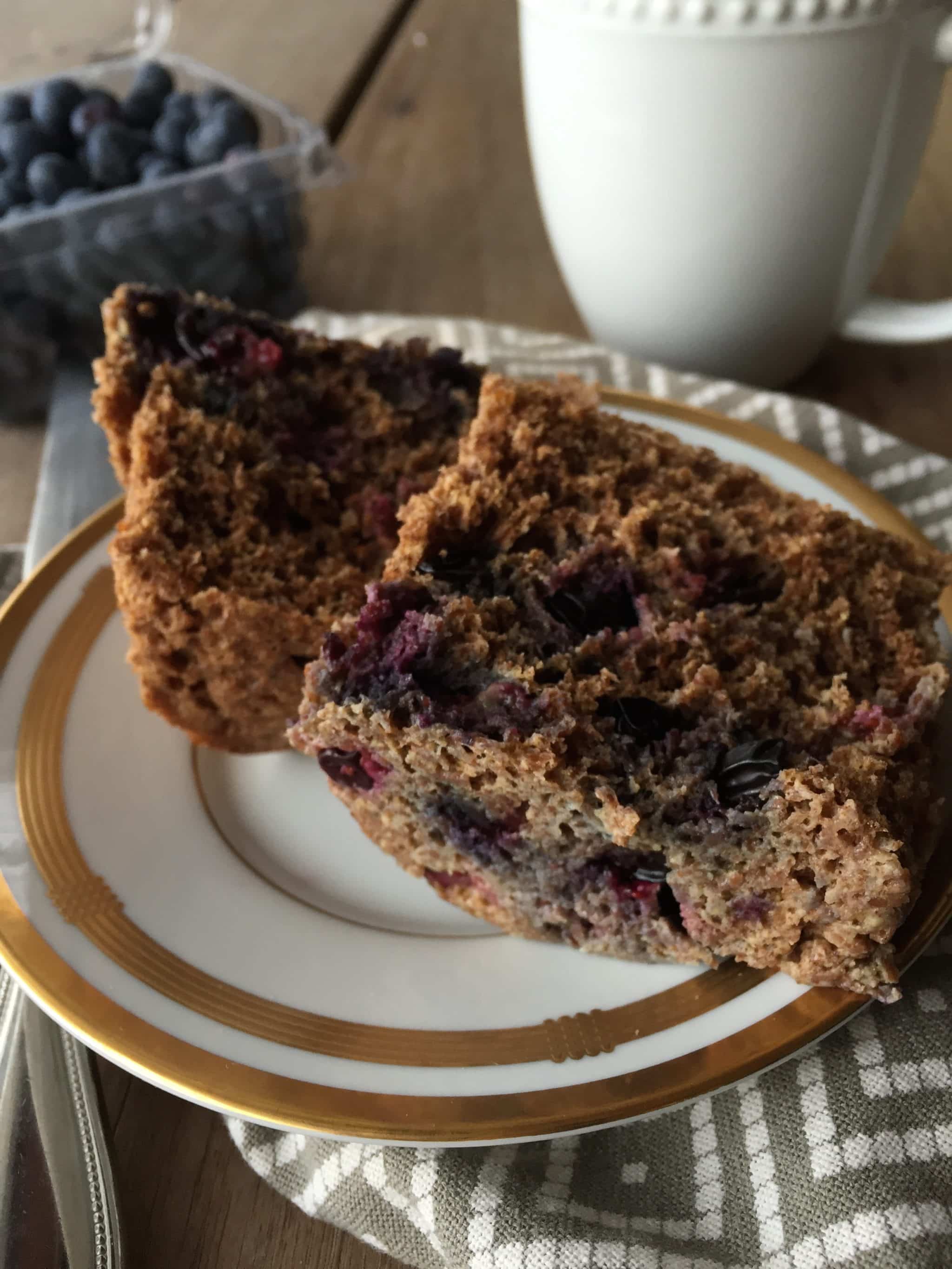 A healthy easy mug muffin sitting on a plate made in just 1 minute with blueberries