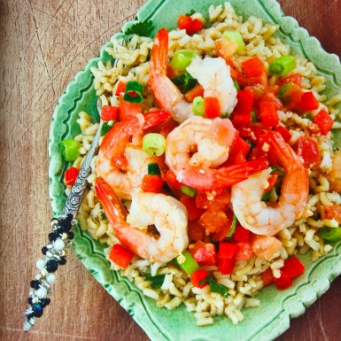 Shrimp and cilantro lime rice with tomato, red pepper on a large plate