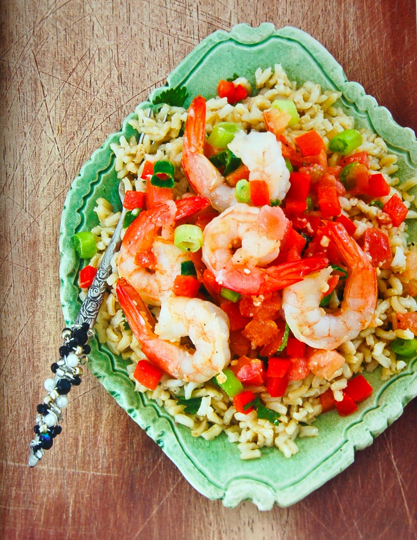 Shrimp and cilantro lime rice with tomato, red pepper on a large plate