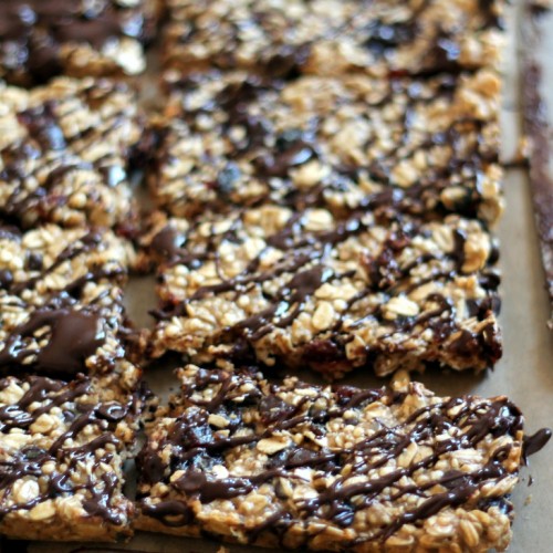 Chewy Dark Chocolate Cherry Protein Granola Bars with Chia Seeds on a baking sheet in the kitchen.