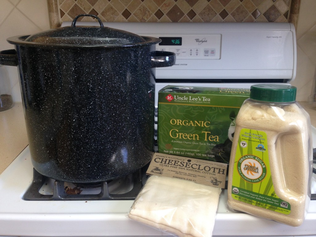 The supplies for brewing your own Kombucha. Tea, yeast, cheese cloth and a large boiling pot.