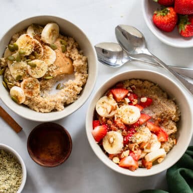 overhead view of two breakfast quinoa bowl servings with different toppings
