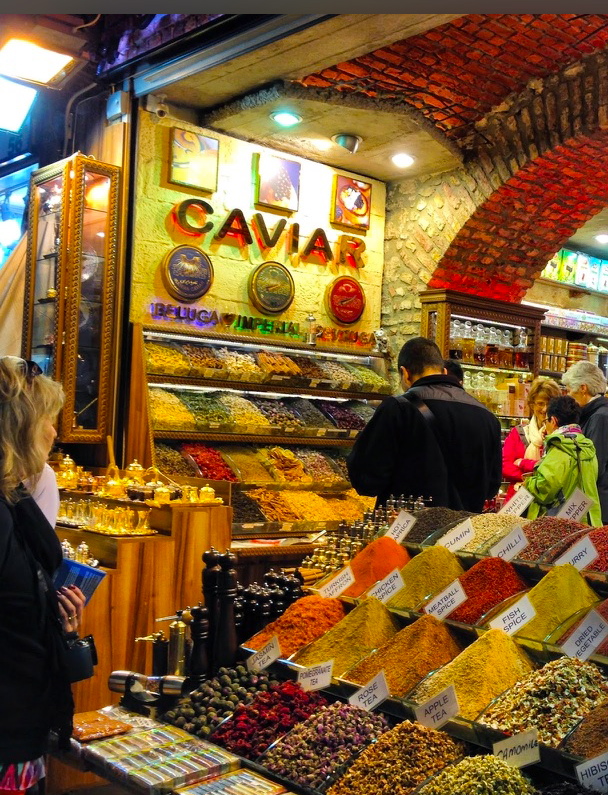 A market in Turkey with tables of fresh and colorful spices like cinnamon and Turmeric.