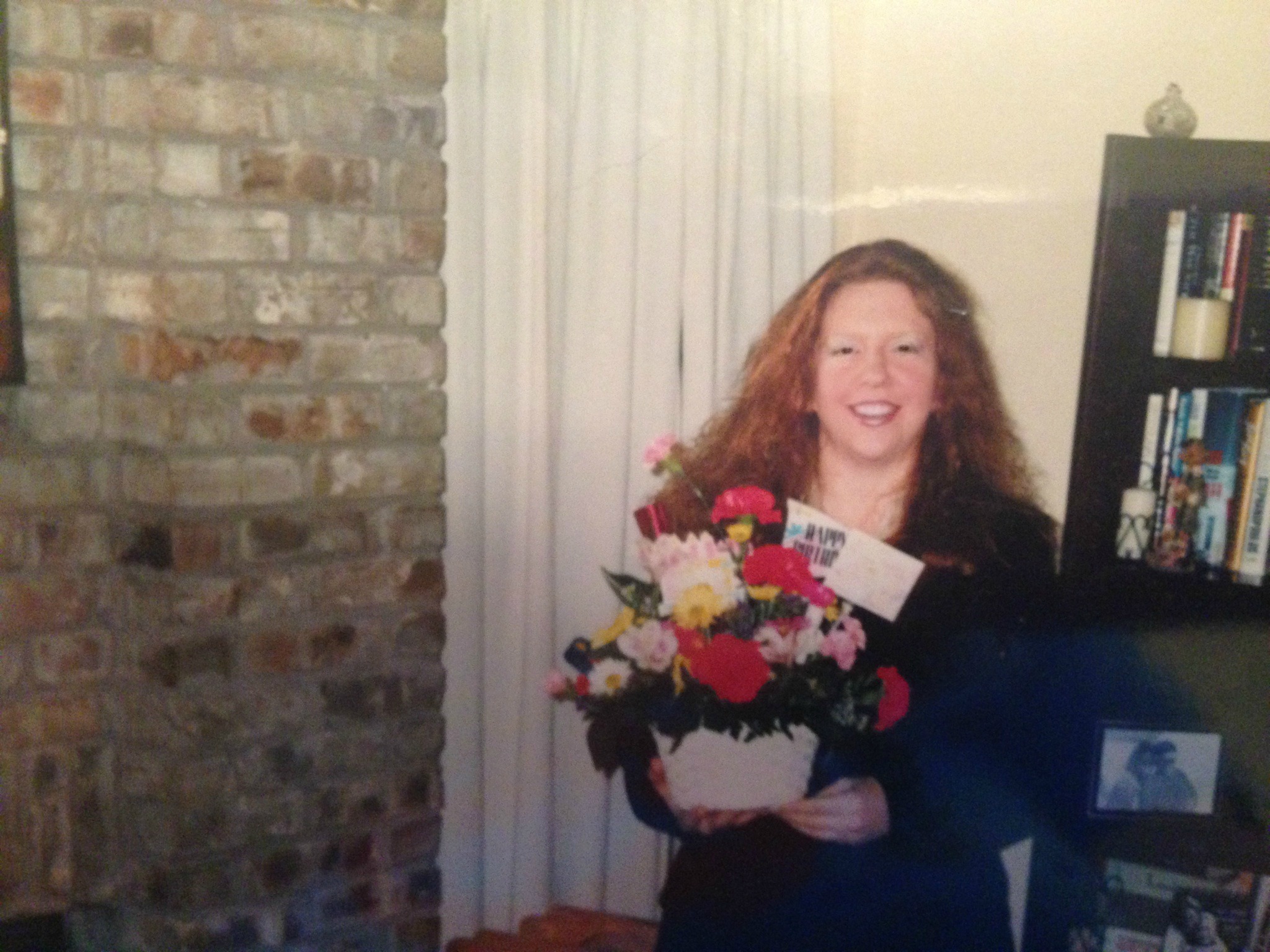 A picture of an overweight woman holding flowers.