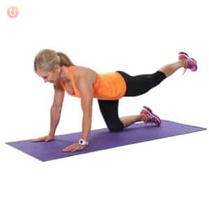 Chris Freytag demonstrating Leg Lifts on a purple yoga mat