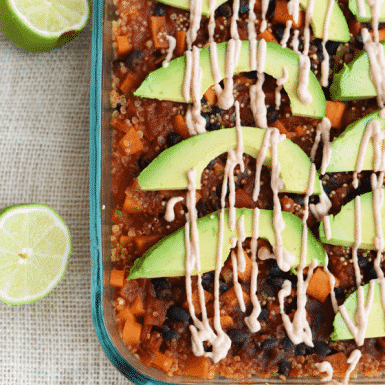 Mexican Quinoa and Sweet Potato Casserole topped with avocado slices and chipolte yogurt drizzle