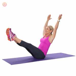 Chris Freytag demonstrating V-ups on a purple yoga mat