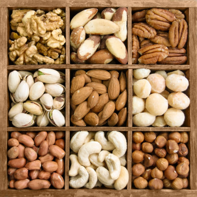 A mix of healthy nuts: walnuts, peanuts, pistachios, and cashews