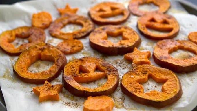 Halloween Sweet Potato Fries in the shape of pumpkins with cinnamon sprinkled on top for a halloween snack idea