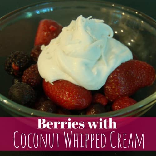 a bowl of berries topped with delicious coconut whipped cream
