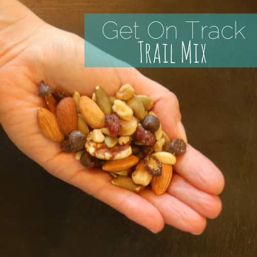 A handful of trail mix with nuts, seeds, and fruit