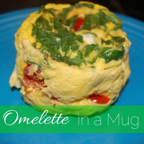 an onlette filled with spinach, chest, and tomatoes