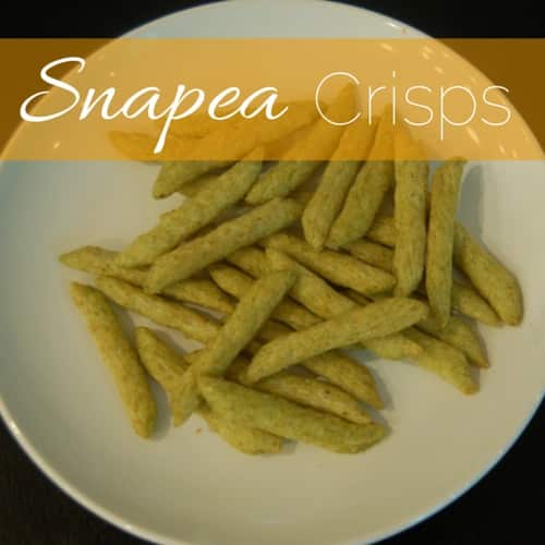 A white plate with a handful of snap pea crisps on it