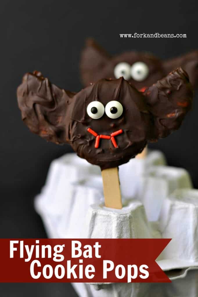 A Flying Bat Cookie Pop with a face made out of frosting as a healthy halloween treat