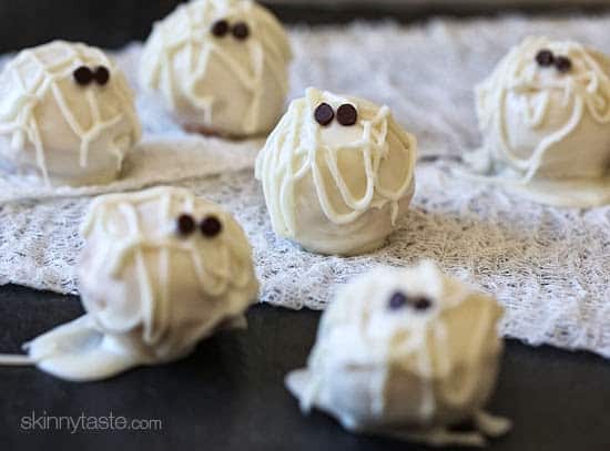 A plate Skinny Mummy Cake Balls with chocolate chips as eyeballs for a healthy halloween treat