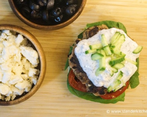 Black olive and feta turkey burgers topped with greek yogurt sauce and pickles