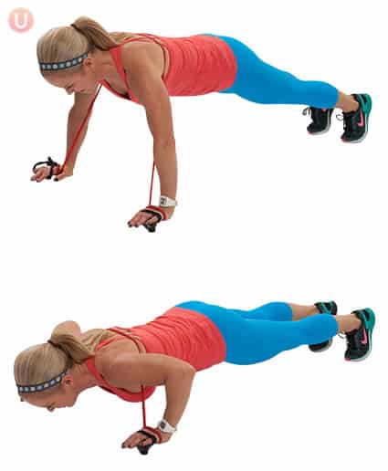 Chris Freytag demonstrating a resistance band push up wearing a red top and blue workout pants