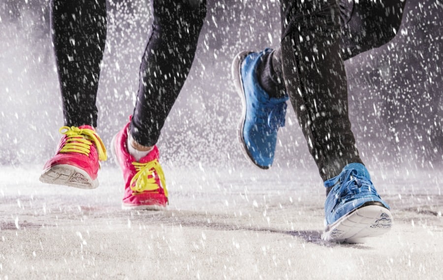 A couple running in a snow rain mix