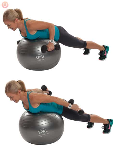 Chris Freytag demonstrating a tricep kickback lying on a stability ball wearing black yoga pants and a blue top