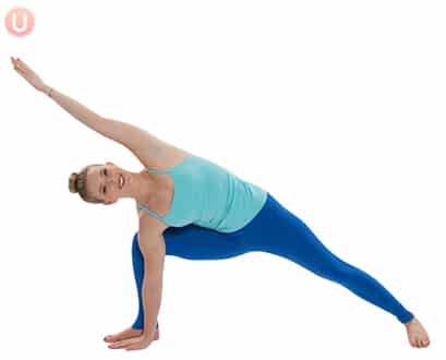 Chloe Freytag demonstrating an Extended Side Angle in a blue tank top and yoga pants