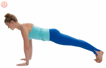 Chloe Freytag demonstrating plank pose in a blue tank top and yoga pants