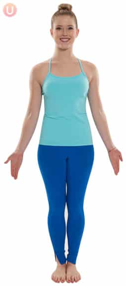 Chloe Freytag demonstrating Mountain Pose in blue yoga pants and a blue tank top
