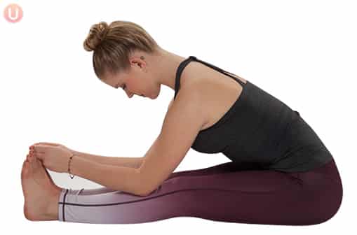 Chloe Freytag demonstrating Seated Forward Fold in a black tank top and yoga pants