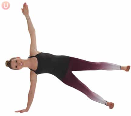 Chloe Freytag demonstrating Side Plank Pose with Leg Lift in a black tank top and yoga pants