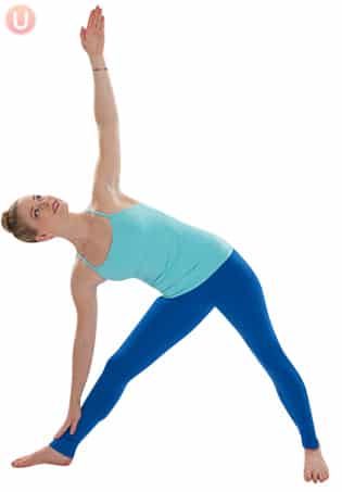 Chloe Freytag demonstrating Triangle pose in a blue tank top and yoga pants.