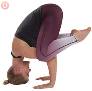 Chloe Freytag demonstrating Tripod Pose in a black tank top and yoga pants
