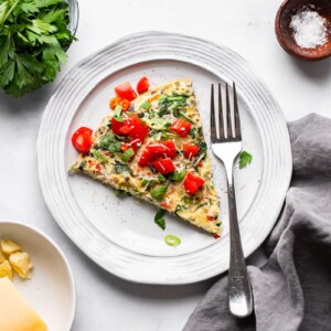 above view of single serving of healthy vegetable frittata on white place place setting