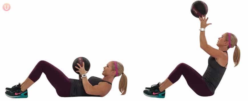 Chris Freytag demonstrating Ab Roll Up Toss in a black tank top holding a black medicine ball