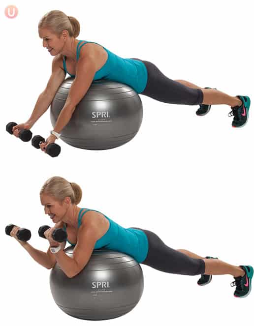 Chris Freytag demonstrating Stability Ball Preacher Curl in a blue tank top on a silver stability ball