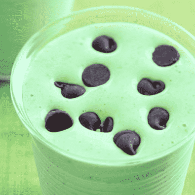 Green shamrock shake in glass with chocolate chips