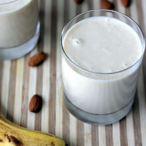 Healthy Almond Butter Banana Oatmeal Smoothie in a glass cup on a table.
