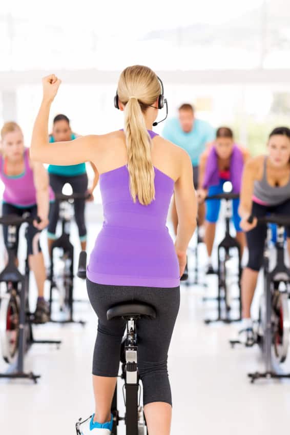 an instructor in a group fitness class for spinning