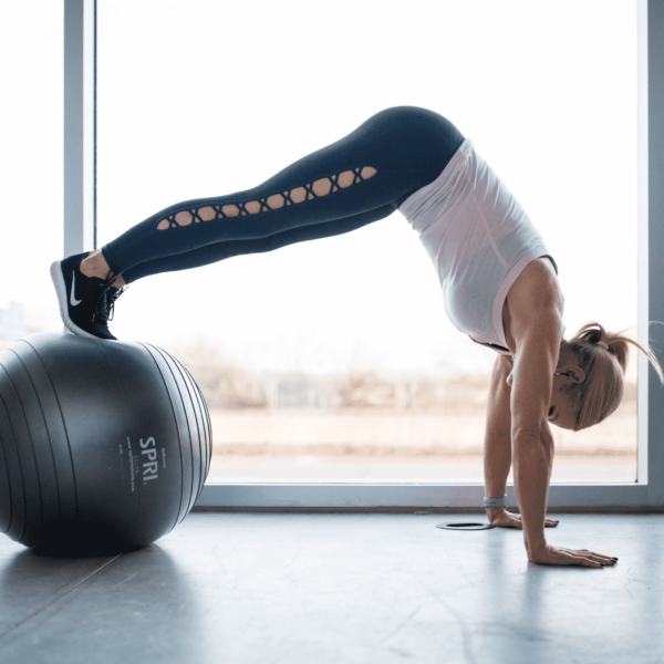 chris freytag doing a different push up on a ball