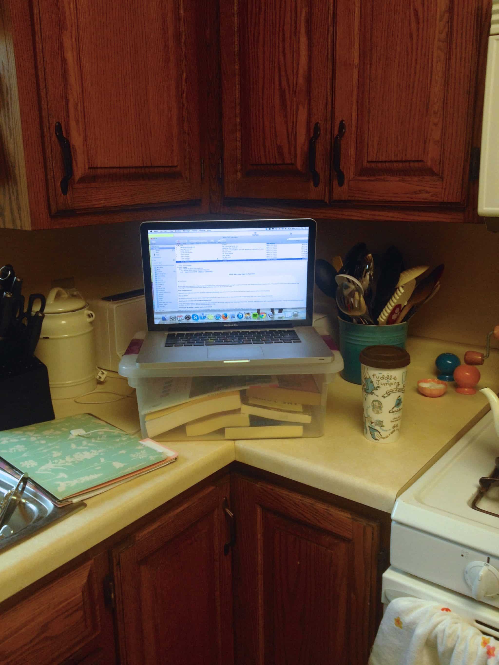 An at-home DIY standing desk using a Tupperware container.