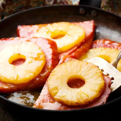 Glazed pineapple ham steak in skillet