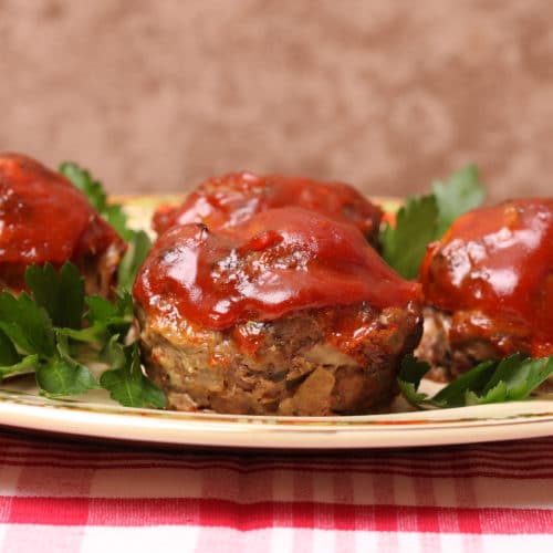 Southwestern turkey meatloaf muffins with ketchup sitting on a plate