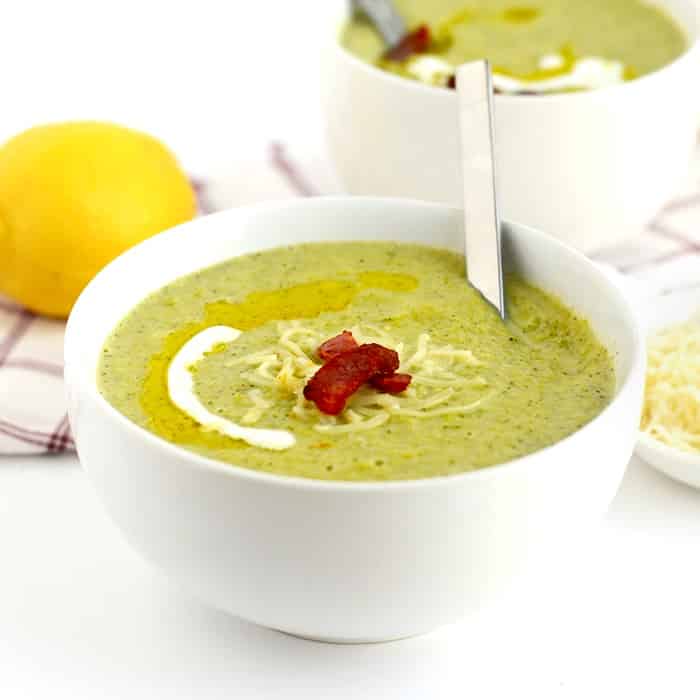 Healthy Low-Fat Broccoli Cheese Soup Recipe in a white bowl on a kitchen counter.