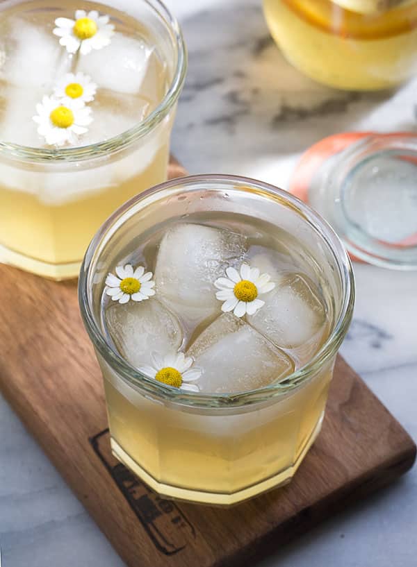 Chamomile Honey and Whiskey Cocktail with daisy garnish