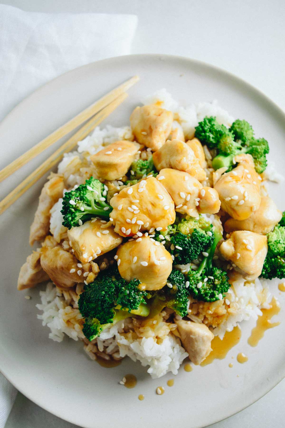 Gluten-free healthy orange chicken on a plate with broccoli and rice