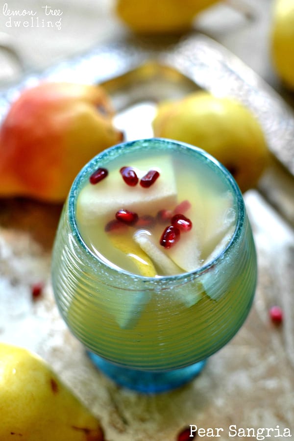 Pear sangria in a glass with pomegranate seeds