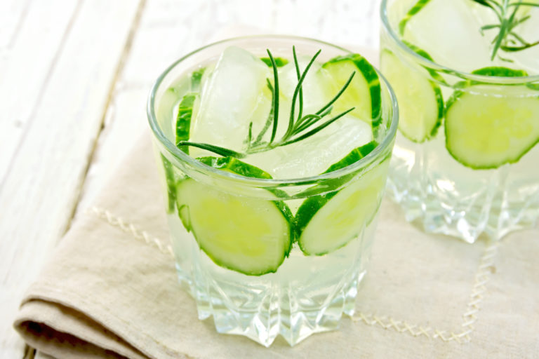 Two solid  of lemonade cocktail with cucumber and rosemary